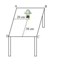How will you describe the position of a table lamp on your study table to another person?